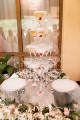 Close up of wedding fountain filled with champagne and cocktail cherry