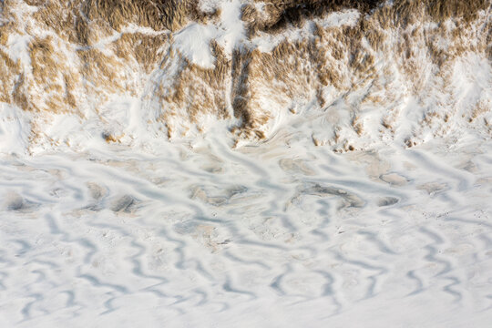 Aerial view of wild white sand beach landscape on Baltic sea coast in Curonian Spit near Klaipeda, Lithuania.