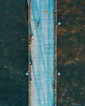 Aerial view of people fishing and walking on bridge in Baltic sea near Palanga, Lithuania.