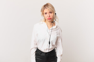 young pretty woman feeling sad and whiney with an unhappy look and crying. telemarketing concept