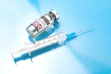 United Kingdom UK coronavirus COVID-19 vaccince vial with syringe, vaccination in Europe concept,...