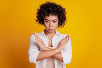 Close up photo serious strict protester lady crossed hands stop sign posing on yellow wall