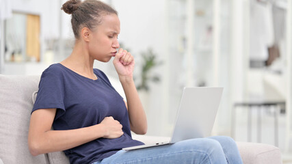 Sick African Woman with Laptop Coughing at Home 