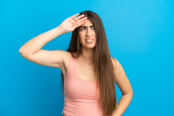 Young caucasian woman isolated on blue background with tired and sick expression