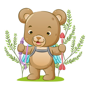 The cute cupid bear is holding the arrow love on her hand and standing in the park