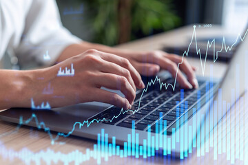 Woman typing the keyboard to research stock market to proceed right investment solutions. Internet trading and wealth management concept. Formal wear. Hologram Forex chart over close up shot.
