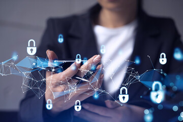 A woman programmer is browsing the Internet in smart phone to protect a cyber security from hacker...