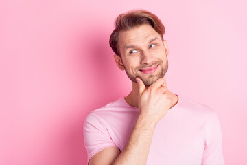 Portrait of positive person hand on chin look empty space smile thinking isolated on pink color background