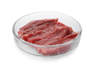 Petri dish with pieces of raw cultured meat on white background