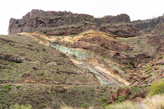 Bluish strata on the inner face of a crater produced by the alteration of minerals by the lava from the volcano. They are known as "Los Azulejos" in Mogán, a town on the island of Gran Canaria, Spain.