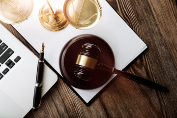 Close up of hand lawyer working signing contract paper with wooden gavel judge in the office. lawyer and law ,judiciary and legislature courtroom legal concept.