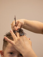 machine haircut Little boy in the barbershop.