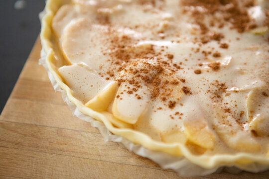Portugal, Lisbon, Close-up of raw apple pie with cinnamon ready to bake