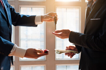 Car leasing concept. Business people pay and received the car keys.