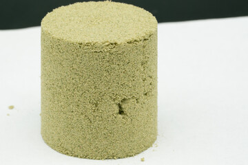 Kief, or dry sift hash, slightly compressed for form a cylinder shape  - obrazy, fototapety, plakaty