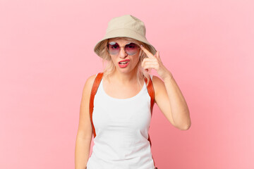 young pretty woman feeling confused and puzzled, showing you are insane. summer tourist concept