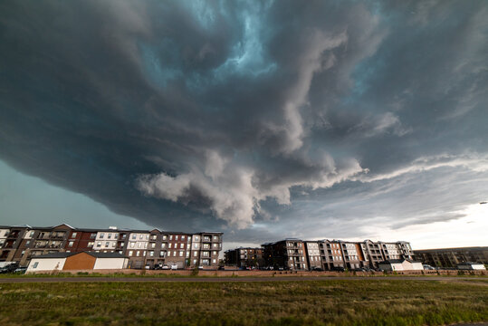 USA, Colorado, Colorado Springs, Tornadic storm clouds over apartment blocks