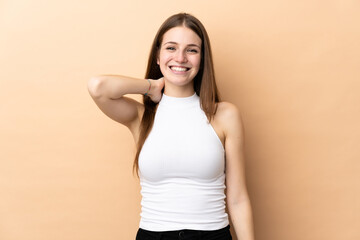 Young caucasian woman isolated on beige background laughing