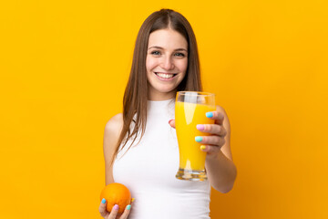 Young caucasian woman holding an orange isolated on orange background