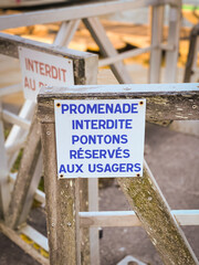 Sign indicating "no walk, pontoon reserved for users" in French on the port of La Teste de Buch, France
