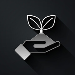 Silver Plant in hand of environmental protection icon isolated on black background. Seed and seedling. Planting sapling. Ecology concept. Long shadow style. Vector