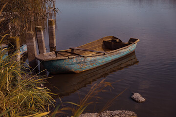Ukraine, Old wooden boat moored on lake
