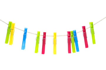 Colorful plastic clothespins hanging on rope against white background