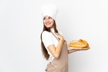 Young woman in chef uniform isolated on white background laughing