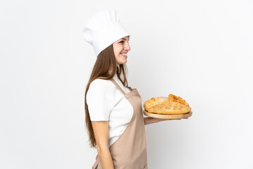 Young woman in chef uniform isolated on white background looking to the side