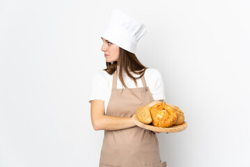 Young woman in chef uniform isolated on white background looking side