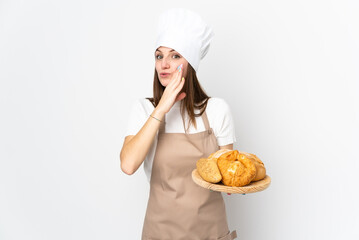 Young woman in chef uniform isolated on white background whispering something