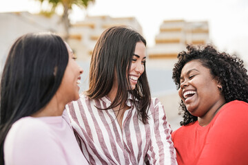 Happy latin women having fun together in the city - Millennial girls and friendship concept
