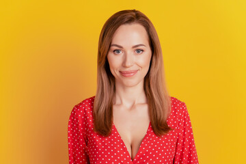 Close-up of a woman smiling wear red dress on yellow wall