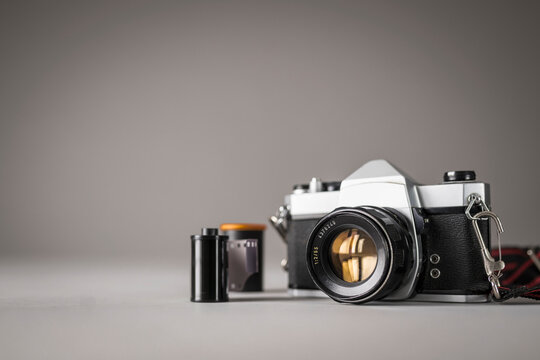 Studio Shot Of Vintage Camera And Film Rolls