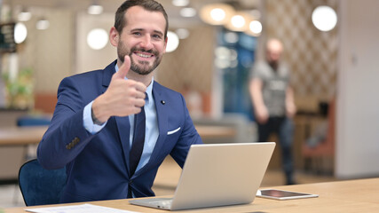 Fototapeta na wymiar Thumbs Up by Positive Middle Aged Businessman working in Office 