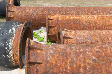 A rusty oil pipeline on the beach