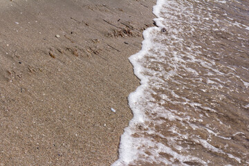The background of sand with water splash into summer with space for text.