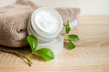 Ecologic concept. Hand made cream in glass boutle with green leaves. Zero waste products for personal care