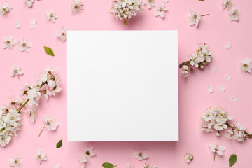 Composition with spring tree blossoms and paper card on pink background, flat lay. Space for text