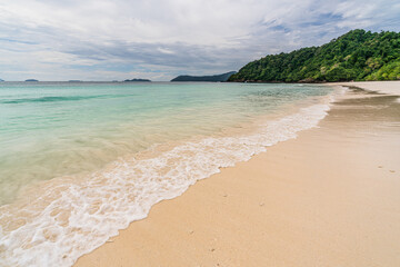 Wave crashing on beautiful beach in Ko Phayam island, Ranong, Thailand.