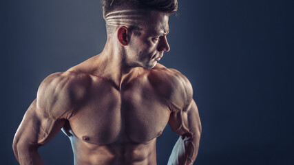 Shirtless male bodybuilder with muscular build strong abs showing. Shot of healthy muscular young...