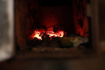 heated stove in the house with red coals and fire