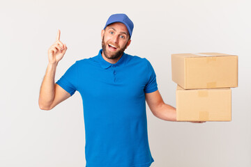young handsome man feeling like a happy and excited genius after realizing an idea. package...