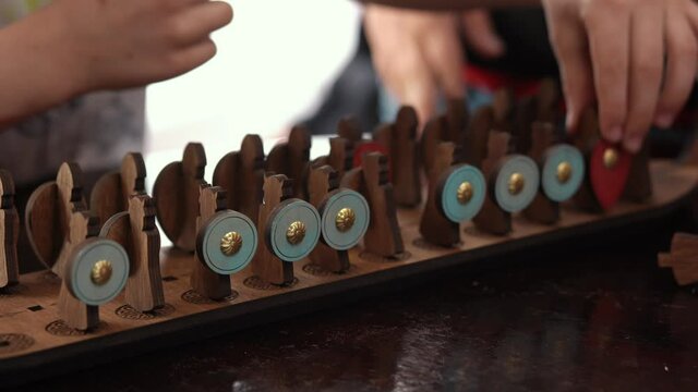 Close up children's hands that play an old board game