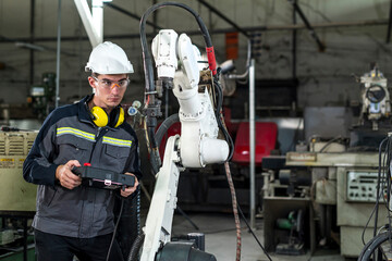 Robotics control engineers solve problems and setting programming of control panel for industrial...
