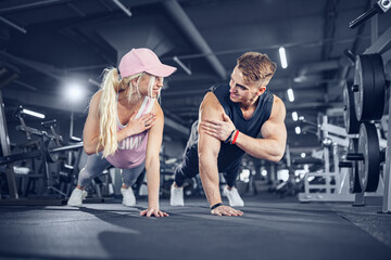 Fototapeta na wymiar Man and woman strengthen hands at fitness training