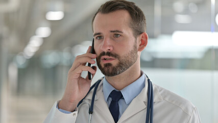 Portrait of Male Doctor Talking on Phone 