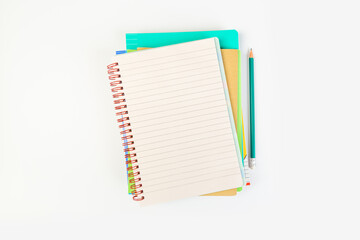 top view of an open notebook with a pencil on a gray background, school notebooks with a spiral spring, office notepad. desktop concept, learning