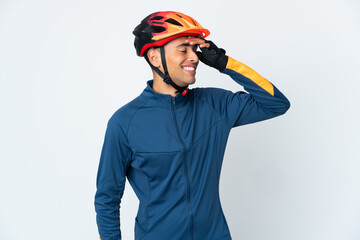 Young cyclist Brazilian man isolated on white background smiling a lot