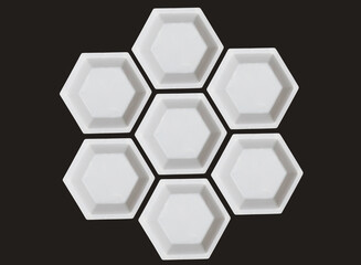 Polygon of hexagons. White plastic hexagonal weighing trays background. Optical illusion. 